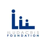 The image shows the logo for "The Ludacris Foundation." The logo features three abstract figures in blue, resembling the letters "L" and "i". Below the figures, the organization's name is written in gray and blue text, reflecting its mission to nurture talent and inspire future influencers.