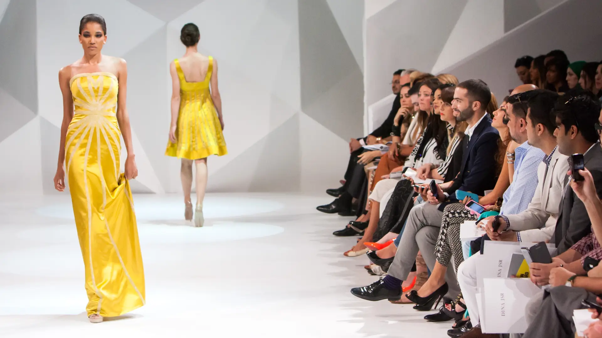 runway model in yellow walking the catwalk