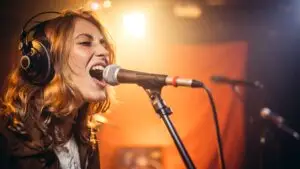 a female singer belting into the microphone