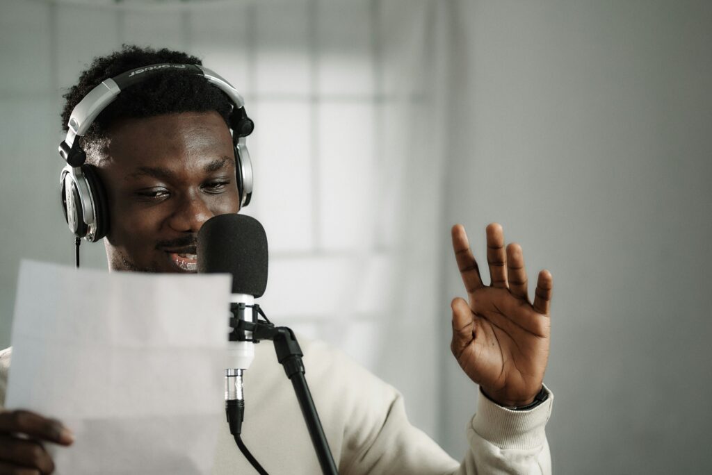 a voice actor reading a script into a microphone