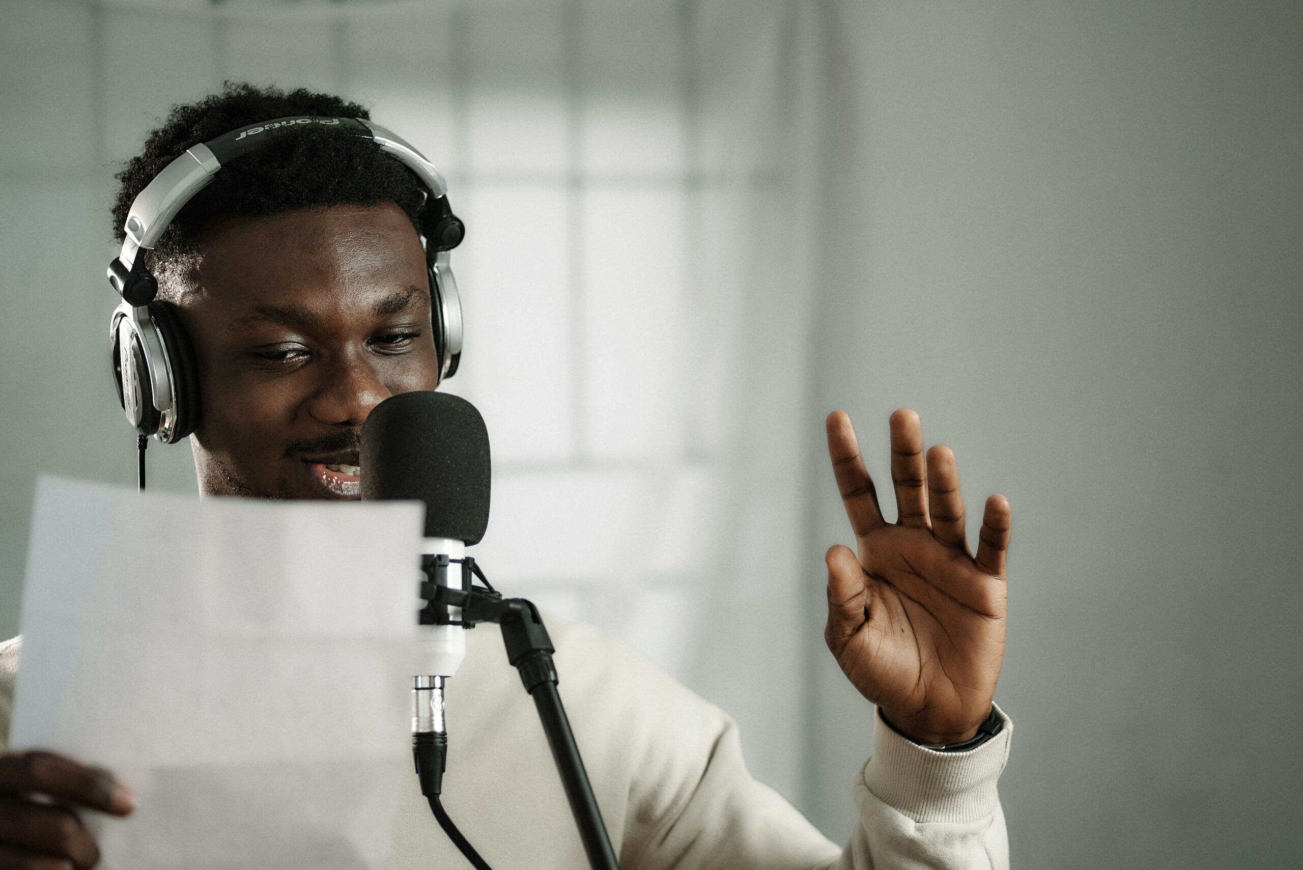 a voice actor reading a script into a microphone