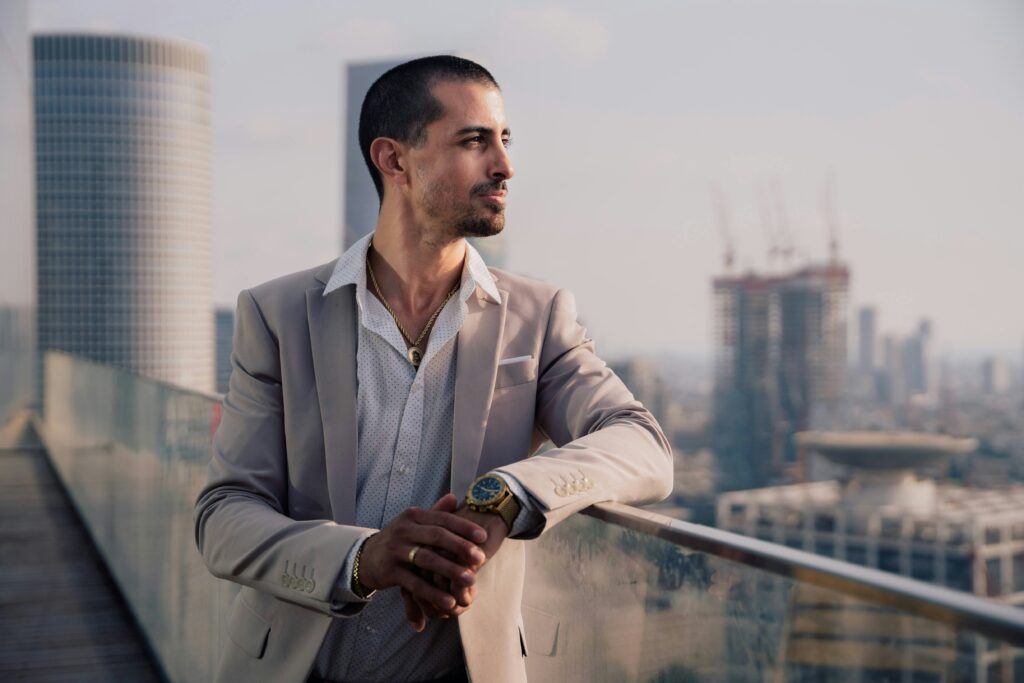 a male model leaning on a balcony